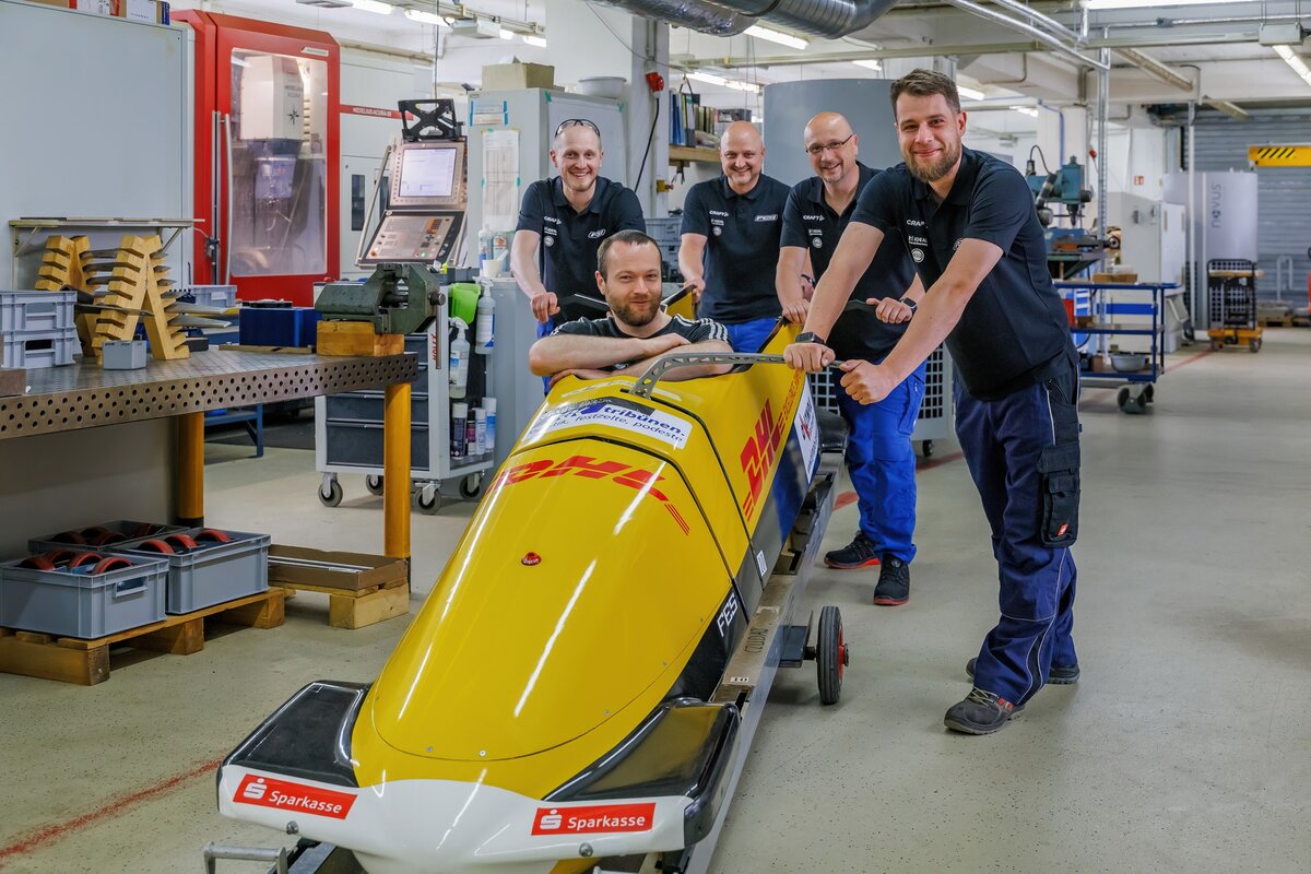 The metal research workshop team proudly presents a competition four man bobsleigh of the German federation