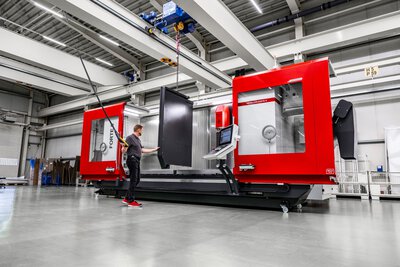 Centro di lavorazione CNC FORTE 9-3600 con operatore durante l'installazione di un divisorio dell'area di lavoro per una separazione sicura dei processi