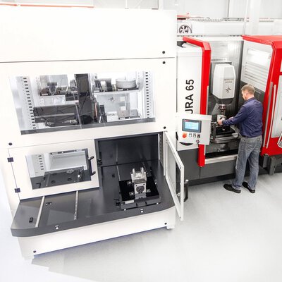 5-Achs-Bearbeitungszentrum mit seitlich angeschlossener Automationslösung Indumatik für Palettenautomation zur effizienten Fertigung.